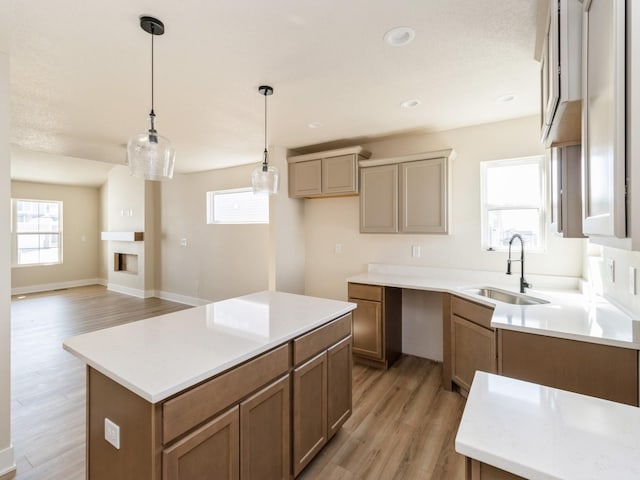 201 S Valley View Dr, Norwalk, IA 50211 - kitchen featuring a sink, light wood finished floors, a kitchen island, plenty of natural light, and recessed lighting