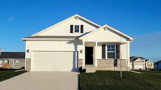 view of front facade with an attached garage, stone siding, a front lawn, and concrete driveway