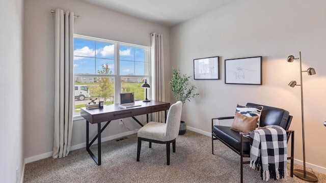 carpeted home office featuring baseboards