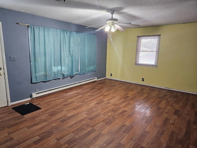 unfurnished room featuring ceiling fan, dark hardwood / wood-style floors, a baseboard radiator, and a textured ceiling