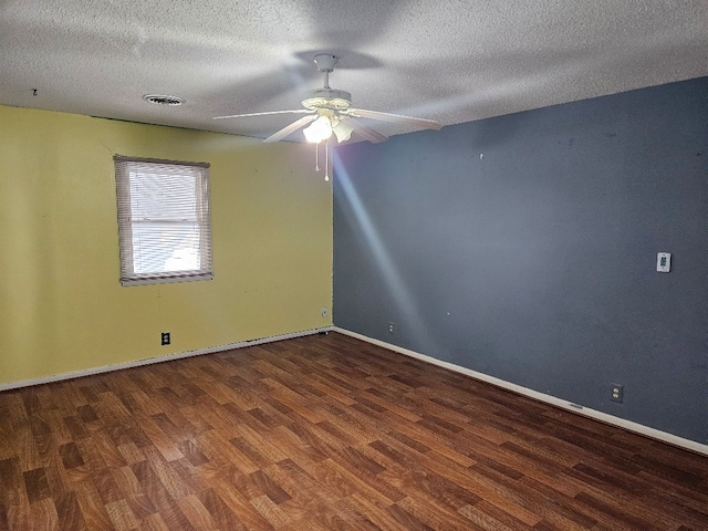 unfurnished room featuring dark wood-type flooring, a textured ceiling, and ceiling fan