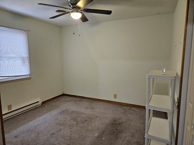 carpeted spare room featuring baseboard heating and ceiling fan