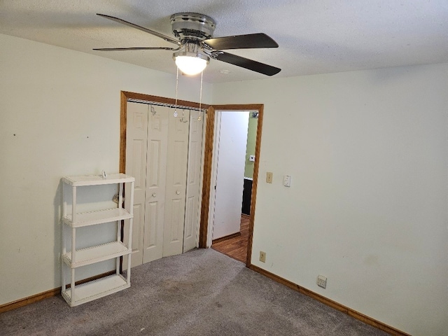 unfurnished bedroom with carpet flooring, a closet, and ceiling fan