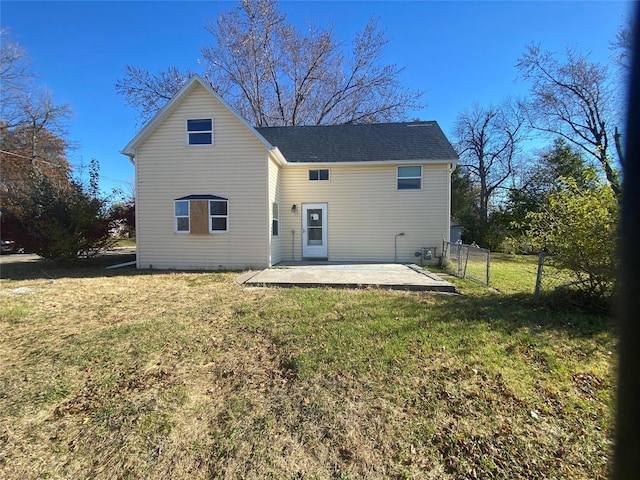 back of property with a patio area and a lawn