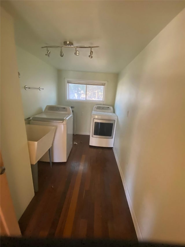 laundry area with dark hardwood / wood-style flooring and independent washer and dryer