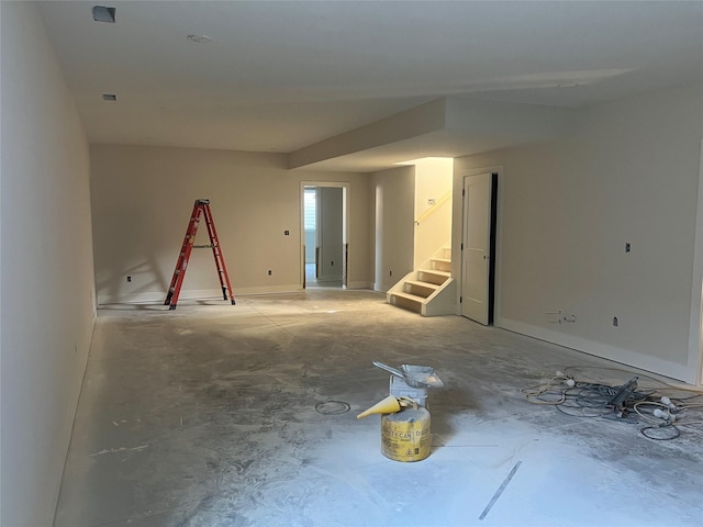 unfurnished room featuring stairway