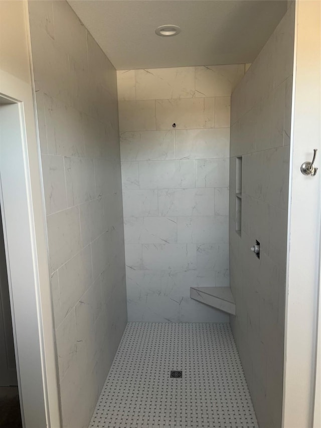 full bathroom with a tile shower