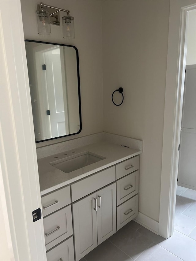 bathroom featuring vanity, tile patterned floors, and baseboards