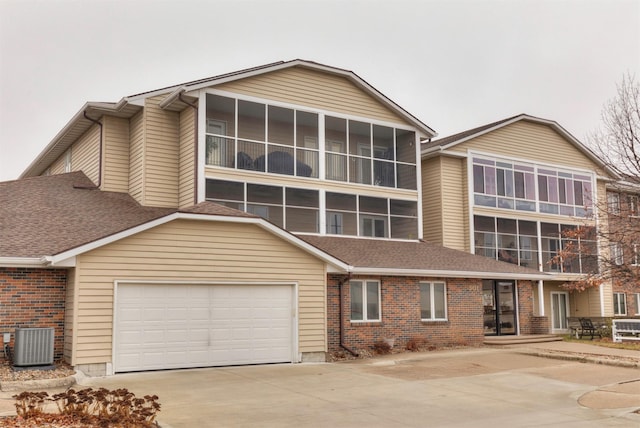 view of front facade featuring central AC and a garage