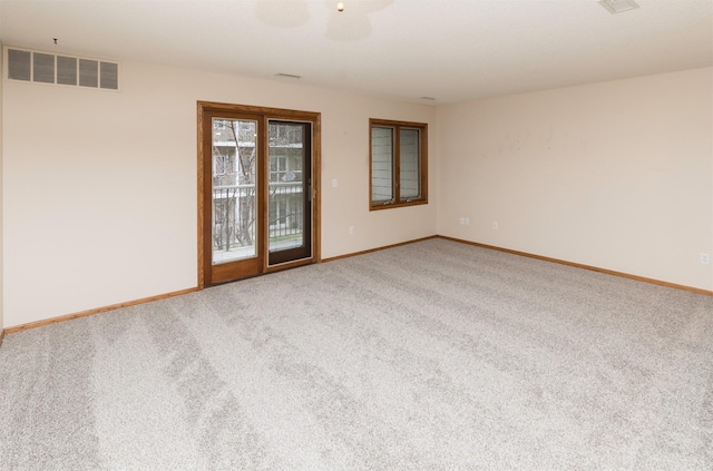 carpeted spare room with ceiling fan