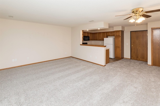 unfurnished living room with light colored carpet and ceiling fan