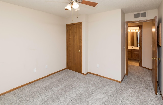 unfurnished bedroom with ceiling fan and light colored carpet