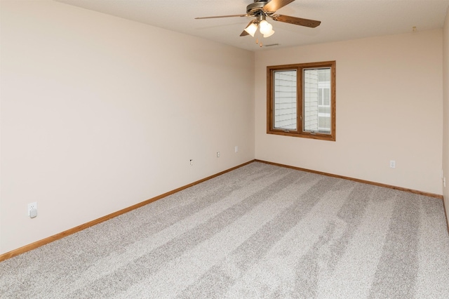 carpeted empty room with ceiling fan