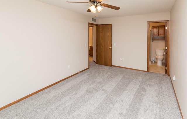 unfurnished bedroom featuring ceiling fan, ensuite bath, light carpet, and a closet