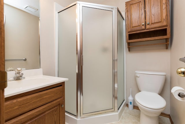 bathroom with vanity, toilet, and a shower with shower door