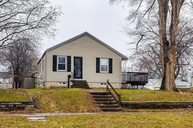 bungalow-style home featuring a front yard