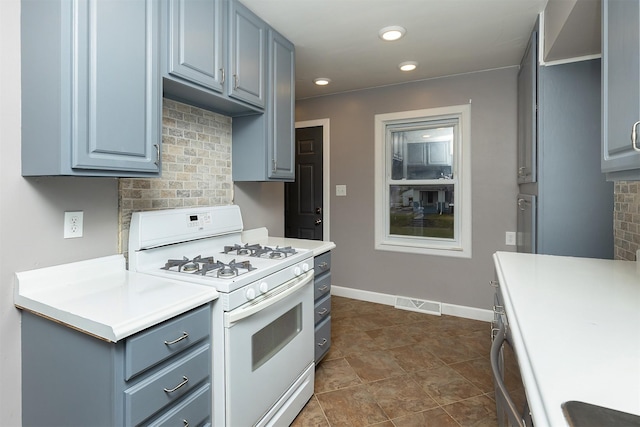 kitchen with tasteful backsplash and white gas range