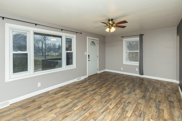 unfurnished room with ceiling fan and dark hardwood / wood-style floors