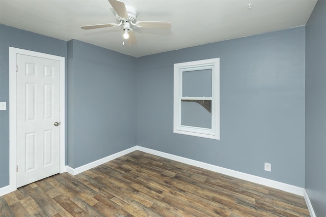 unfurnished room with ceiling fan and dark hardwood / wood-style flooring