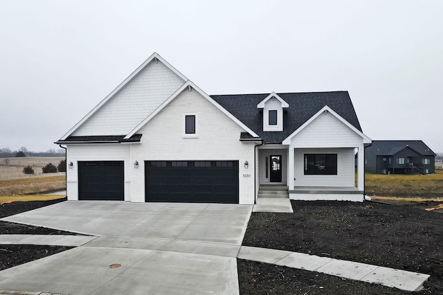 modern farmhouse featuring covered porch and a garage