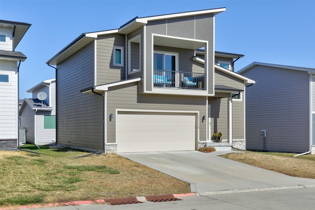 view of front facade featuring a balcony and a garage