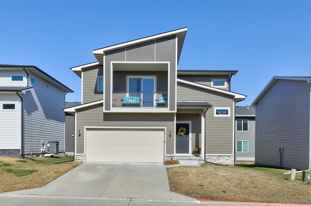 view of front of home featuring a garage, central air condition unit, and a balcony