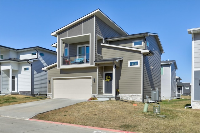 view of front of property with a front yard, a balcony, a garage, and central AC unit