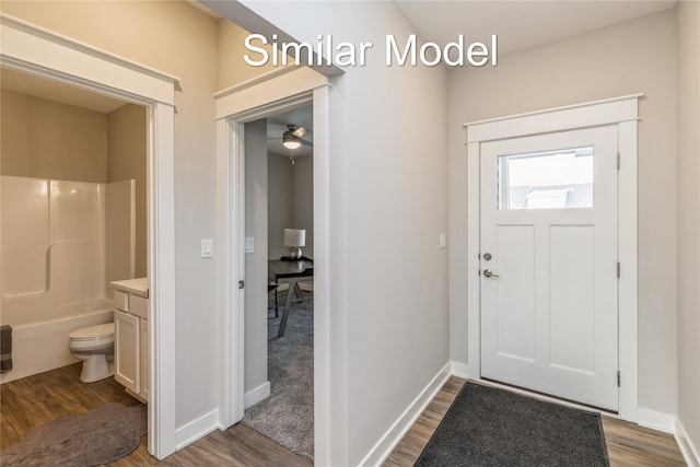 foyer with hardwood / wood-style floors and ceiling fan