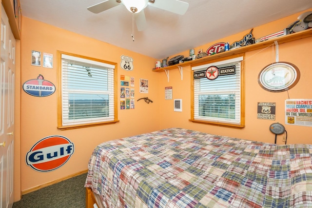 bedroom with ceiling fan, a closet, and dark colored carpet