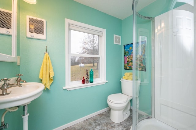 bathroom with toilet and a shower with shower door