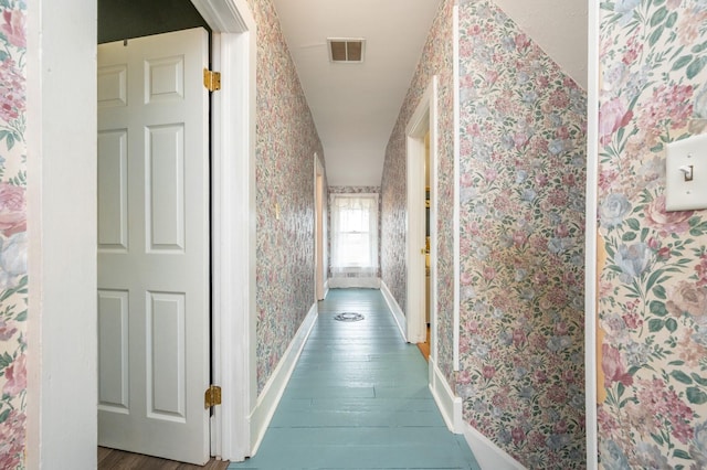 hallway with dark hardwood / wood-style flooring