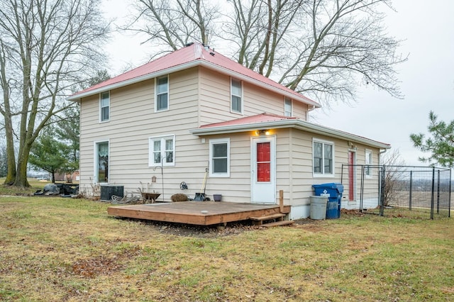 rear view of house with a wooden deck, cooling unit, and a yard