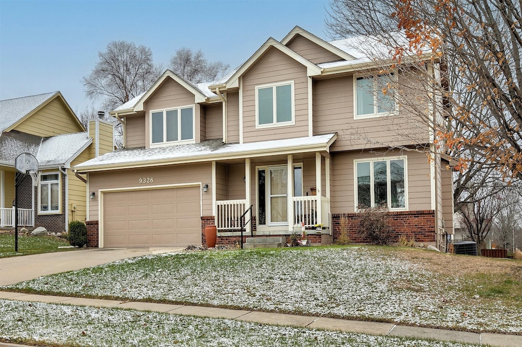 craftsman inspired home featuring brick siding, driveway, and an attached garage