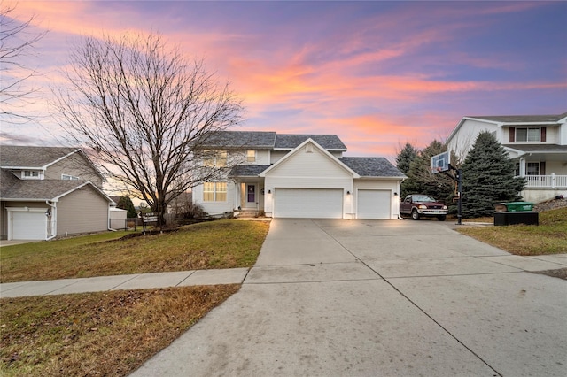 view of front property with a yard and a garage