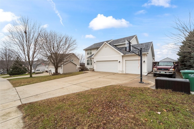 view of side of property with a lawn and a garage