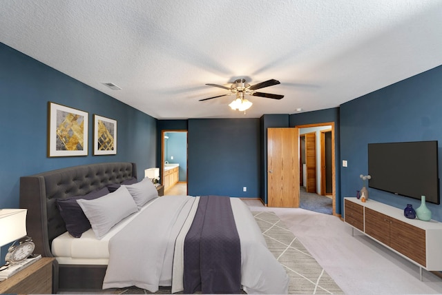 bedroom with baseboards, visible vents, carpet floors, ceiling fan, and a textured ceiling