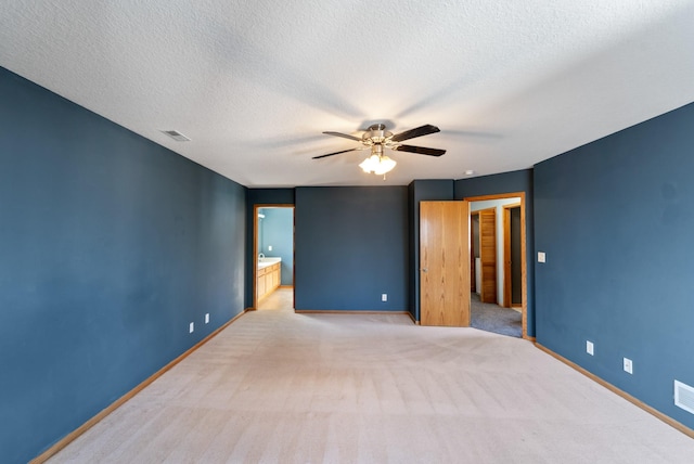 interior space with visible vents, baseboards, light carpet, a textured ceiling, and a ceiling fan