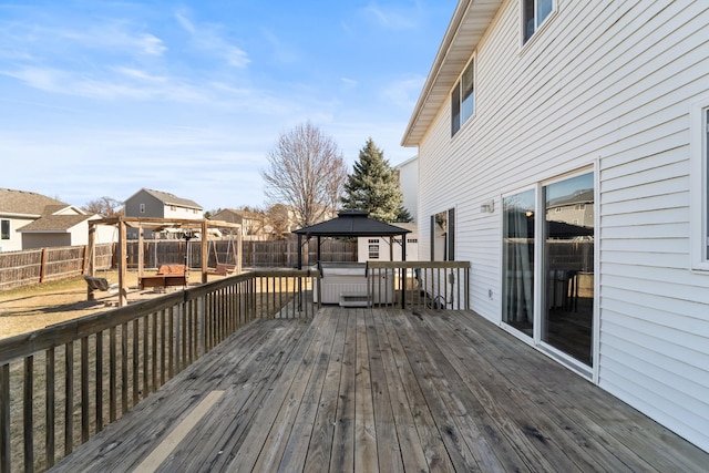 wooden terrace with a gazebo and a fenced backyard