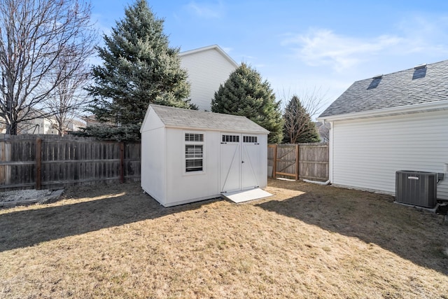 view of shed featuring cooling unit and a fenced backyard