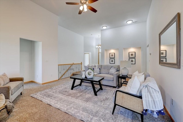 carpeted living room featuring a high ceiling and ceiling fan