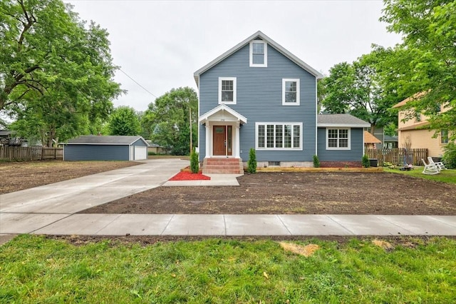 view of front of property with a garage and an outdoor structure