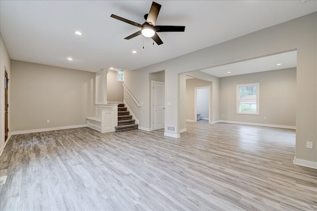 unfurnished living room featuring ceiling fan and light wood-type flooring