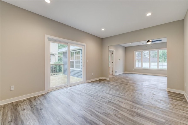 empty room featuring ceiling fan and light hardwood / wood-style floors