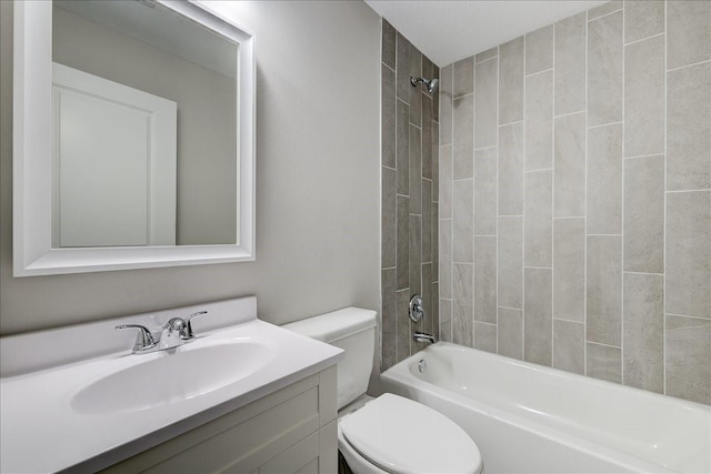 full bathroom with tiled shower / bath, vanity, and toilet