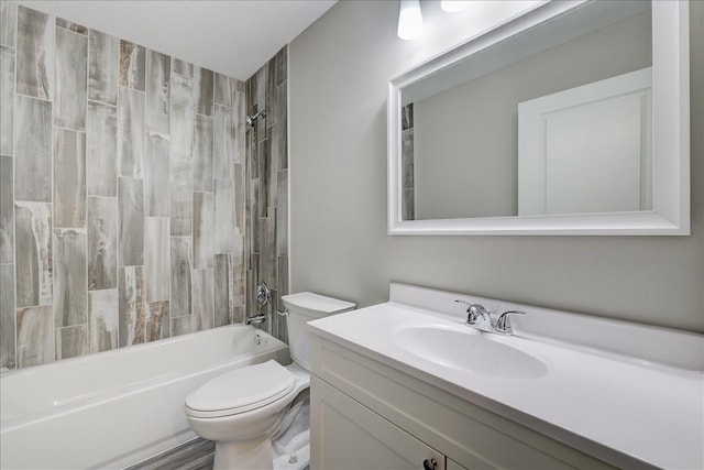 full bathroom featuring washtub / shower combination, vanity, and toilet