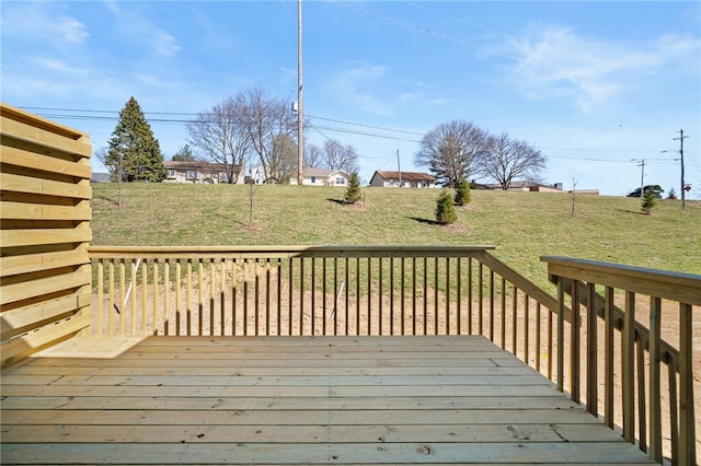 wooden deck featuring a lawn