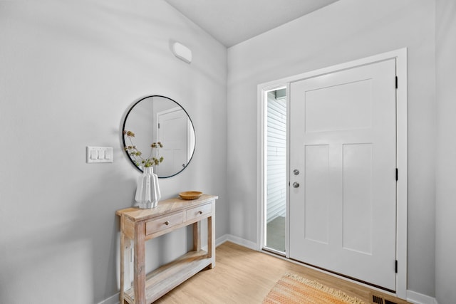 foyer featuring plenty of natural light and light hardwood / wood-style flooring