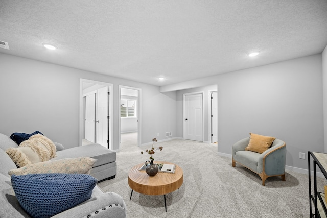 living room with light colored carpet and a textured ceiling