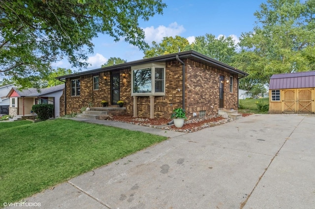 single story home featuring a front yard and a storage shed