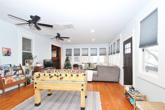 playroom featuring ceiling fan and light hardwood / wood-style flooring